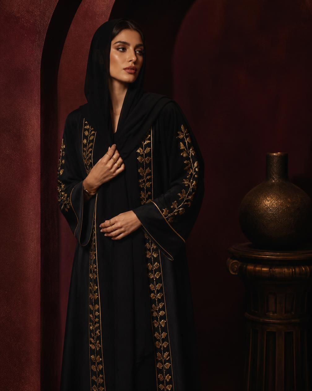 Emirati model wearing a black abaya with gold embroidery